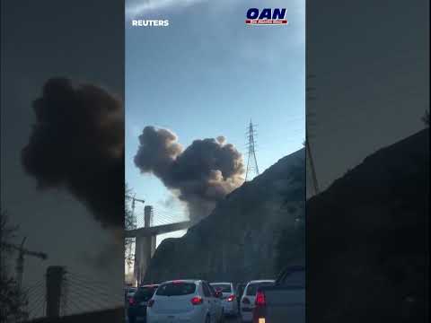 Smoke rising from the B1 highway bridge in Iran after it was hit by air strikes