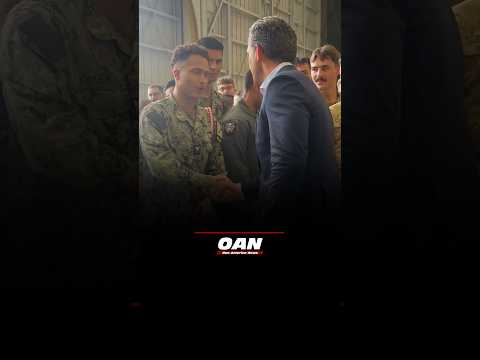 Secretary of War Pete Hegseth shakes hands with U.S. service members